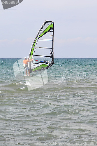 Image of The man is engaged in windsurfing in the sea