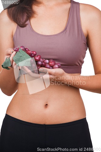 Image of Beautiful woman holding a bunch of grapes