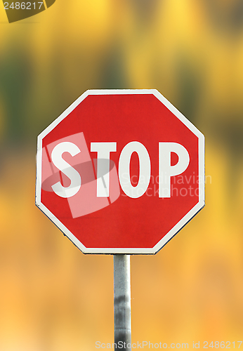 Image of stop sign over autumn background