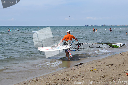 Image of The man is engaged in windsurfing in the sea