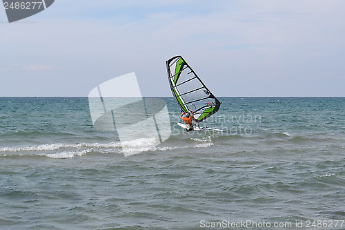 Image of The man is engaged in windsurfing in the sea