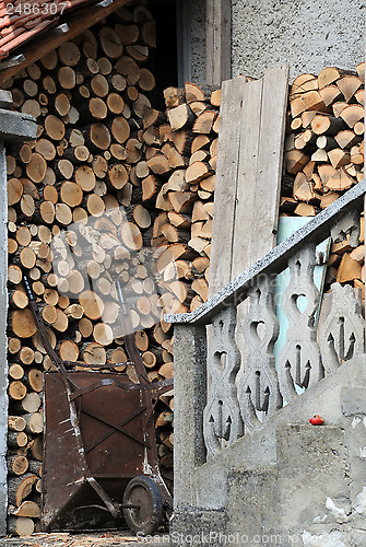 Image of Stack of Woods and Rusty Cart