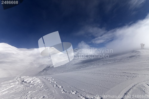 Image of Ski slope with snowmobile trail