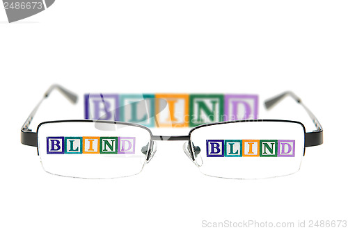 Image of Letter blocks spelling blind through a pair of glasses