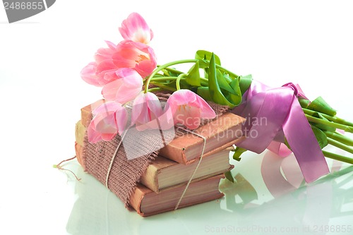 Image of Pink tulips on old books