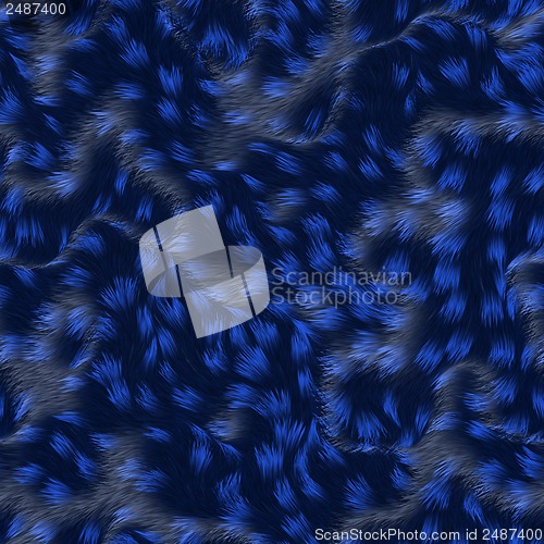 Image of strands of fabric on a soft blue pillow.