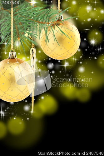 Image of Pine branch with golden Christmas balls.