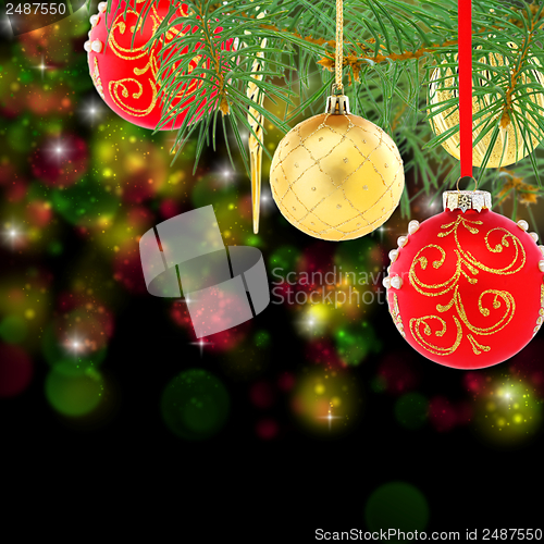 Image of Red and gold christmas balls on spruce branch.