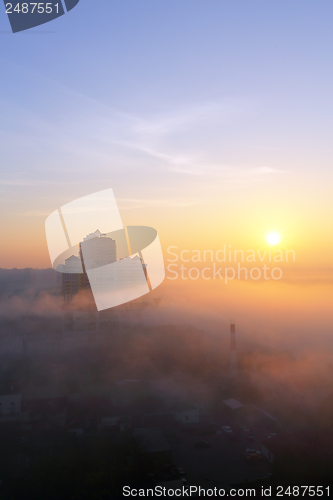 Image of Sun over the foggy city.