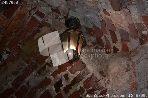 Image of Old red bricks wall and light hanging on the wall