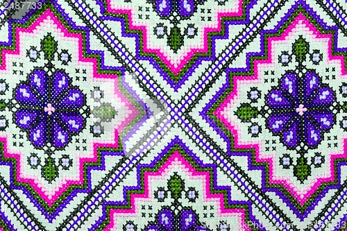 Image of Cross stitch embroidery on canvas.