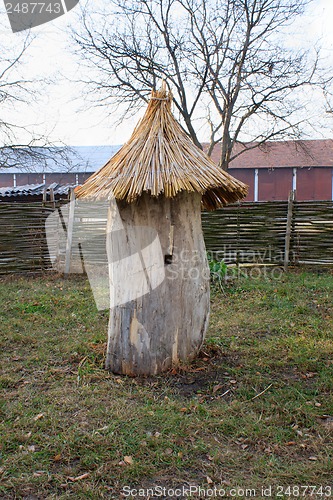 Image of Old wooden bee hive on a background of grass