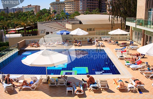 Image of sunbathing by the pool