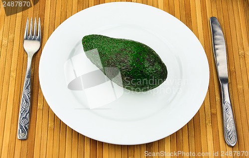 Image of avocado on a plate with cutlery