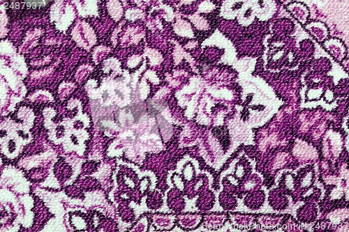 Image of Fragment of colorful retro tapestry textile pattern with floral ornament