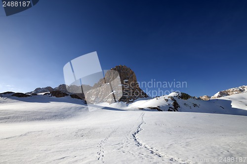 Image of Snowy plateau and footpath against rock and blue sky in nice day