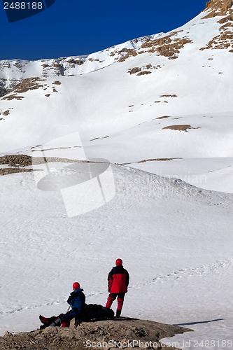 Image of Two hikers on halt in snow mountains