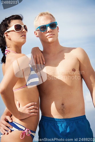 Image of attractive young couple in swimwear and sunglasses