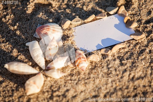 Image of sailing boat and seashell in sand decoration closeup