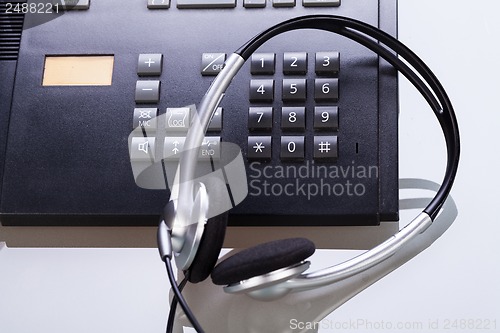 Image of office desk with telephone and headset objects 