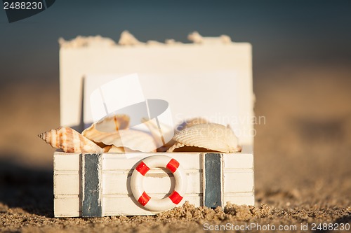 Image of sailing boat and seashell in sand decoration closeup