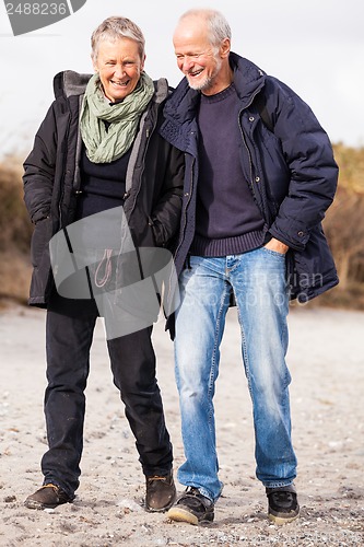 Image of happy mature couple relaxing baltic sea dunes 