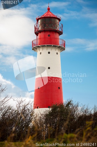 Image of landscape baltic sea dunes lighthouse in red and white 