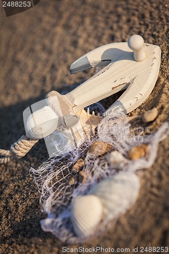 Image of sailing boat and seashell in sand decoration closeup