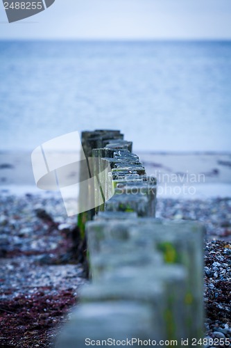 Image of baltic sea background evening wooden wave breaker beach