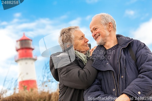 Image of happy mature couple relaxing baltic sea dunes 