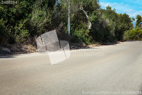Image of empty road in sunlight blue sky destination