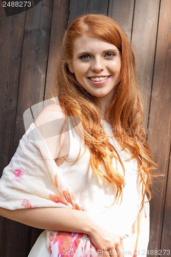 Image of beautiful smiling young redhead woman portrait outdoor