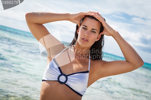 Image of beautiful young brunette woman in bikini sea ocean 