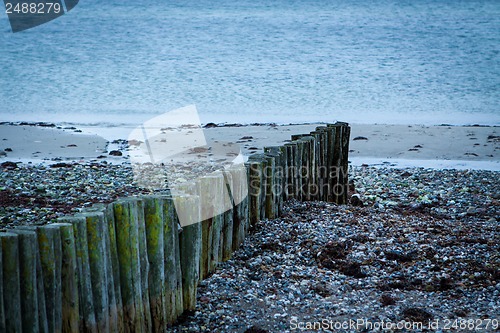 Image of baltic sea background evening wooden wave breaker beach