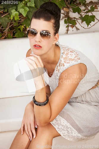 Image of attractive brunette woman with sunglasses and red lips 
