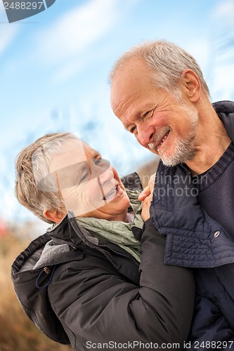 Image of happy mature couple relaxing baltic sea dunes 