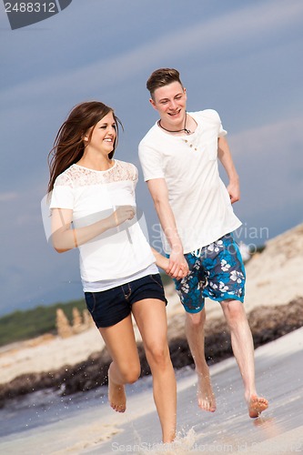 Image of happy young couple on the beach in summer holiday love