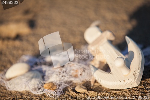 Image of sailing boat and seashell in sand decoration closeup