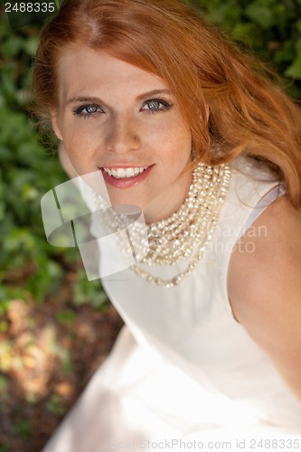 Image of beautiful smiling young redhead woman portrait outdoor