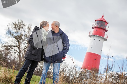 Image of happy mature couple relaxing baltic sea dunes 