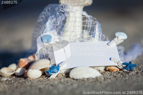 Image of sailing boat and seashell in sand decoration closeup