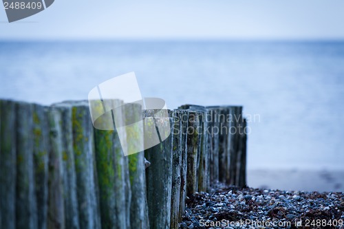 Image of baltic sea background evening wooden wave breaker beach