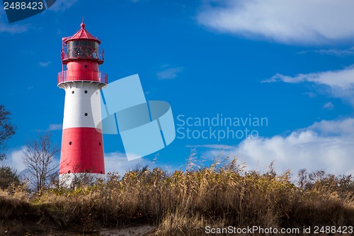 Image of landscape baltic sea dunes lighthouse in red and white 