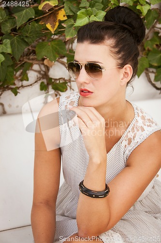 Image of attractive brunette woman with sunglasses and red lips 
