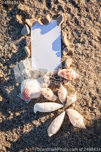 Image of sailing boat and seashell in sand decoration closeup