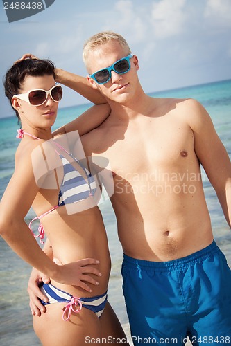 Image of attractive young couple in swimwear and sunglasses
