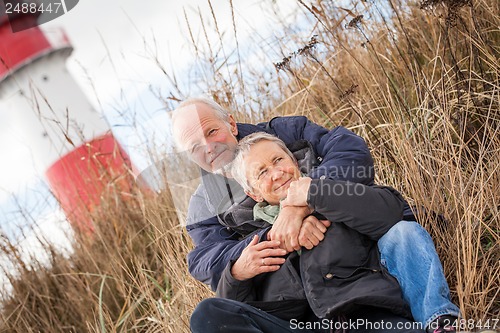 Image of happy mature couple relaxing baltic sea dunes 