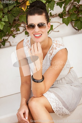 Image of attractive brunette woman with sunglasses and red lips 