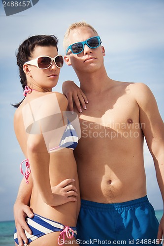 Image of attractive young couple in swimwear and sunglasses