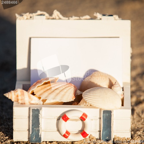 Image of sailing boat and seashell in sand decoration closeup